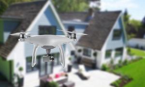 无人四旋翼直升机在房子前的半空中飞行|无人机和侵犯隐私
